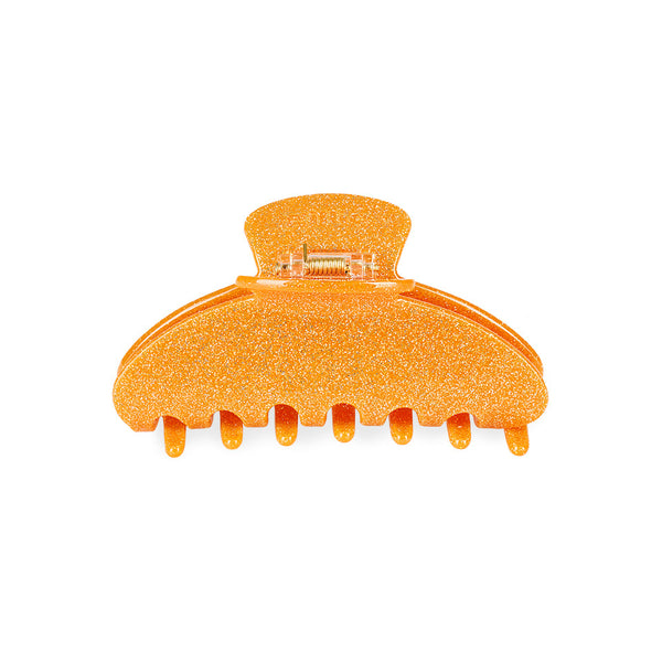 eine große Haarklammer in Orange Glitzer.